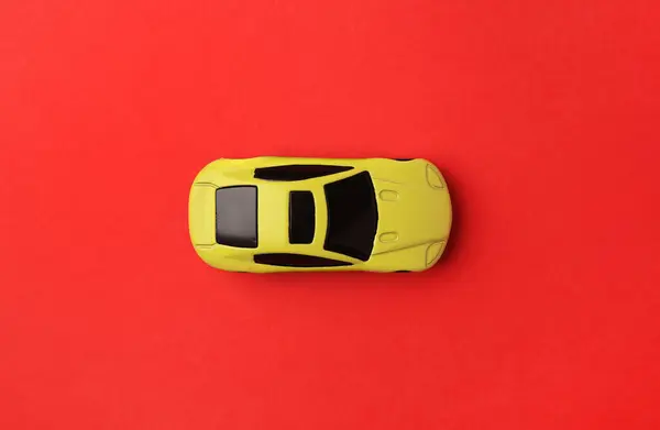 Jedno Žluté Auto Červeném Pozadí Horní Pohled — Stock fotografie