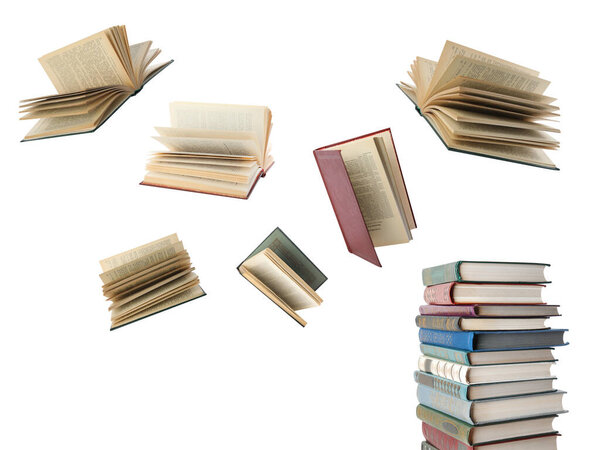 Books flying over stack on white background
