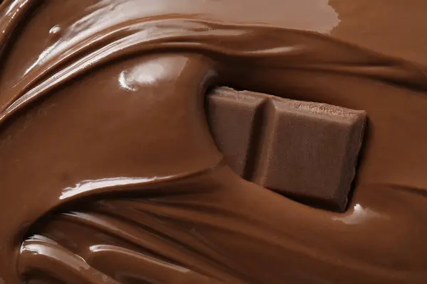 Tasty milk chocolate paste and pieces as background, closeup