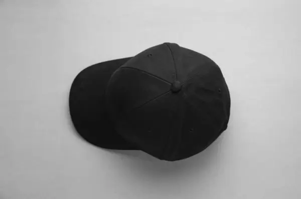 Stylish black baseball cap on light grey background, top view