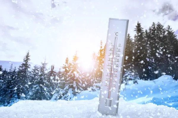 Weather thermometer under falling snow outdoors on winter day, space for text