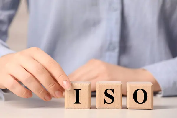 Woman Making Abbreviation Iso Wooden Cubes White Table Closeup — Stock Photo, Image