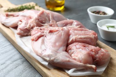 Taze çiğ tavşan bacakları siyah masada, yakın plan.