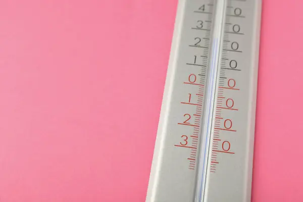 Weather thermometer on pink background, closeup. Space for text