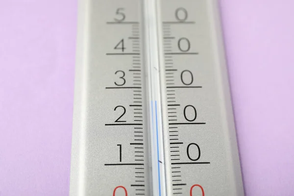 Modern weather thermometer on lilac background, closeup