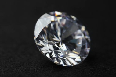 Beautiful shiny diamond on black background, closeup