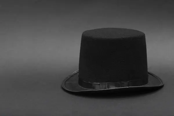 One magician top hat on dark grey background, space for text