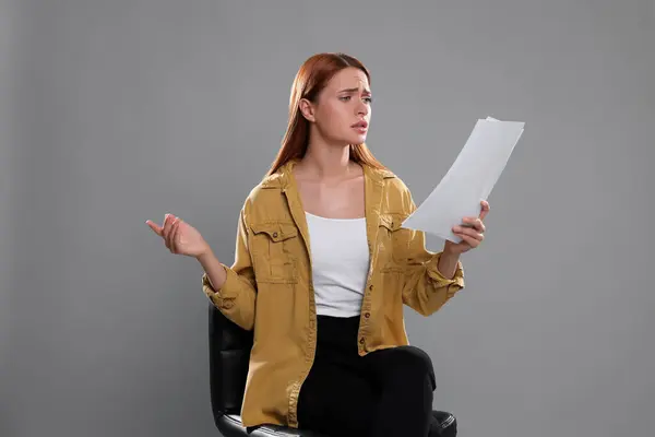 Casting call. Emotional woman with script performing on grey background