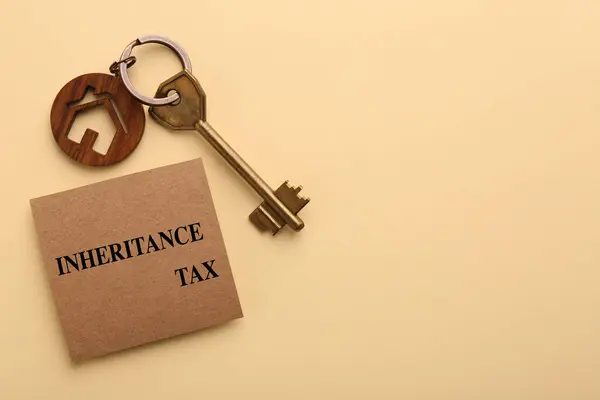 Inheritance Tax. Card and key with key chain in shape of house on beige background, top view. Space for text