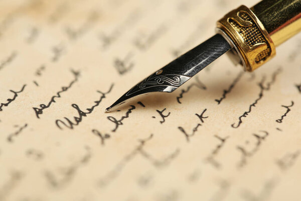 One fountain pen on handwritten letter, closeup