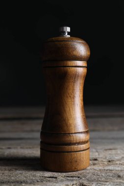 Salt or pepper shaker on wooden table, closeup clipart