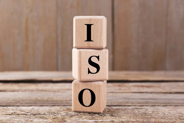 International Organization for Standardization. Cubes with abbreviation ISO on wooden table