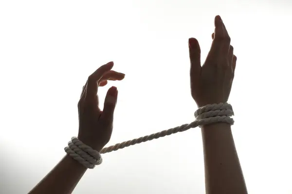 Freedom concept. Woman with tied arms on white background, closeup