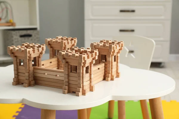 Wooden fortress on white table indoors. Children\'s toy