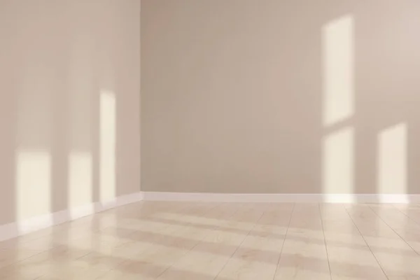 Light and shadows from window on floor and walls indoors