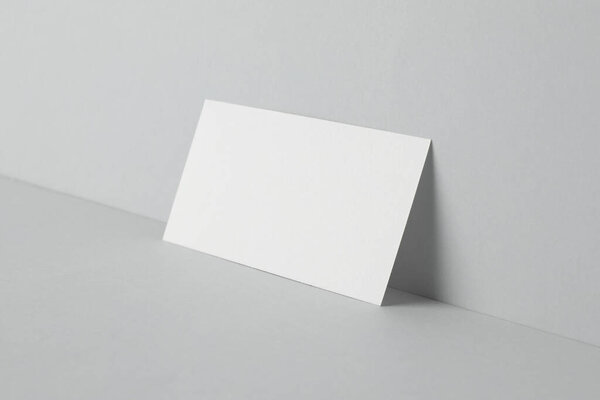 Blank business card on light grey background. Mockup for design
