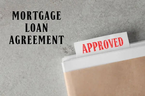 Mortgage loan agreement. Note with Approved stamp in documentation on light grey table, top view
