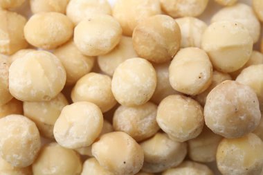 Arka plan olarak lezzetli soyulmuş Macadamia fındıkları, üst görünüm