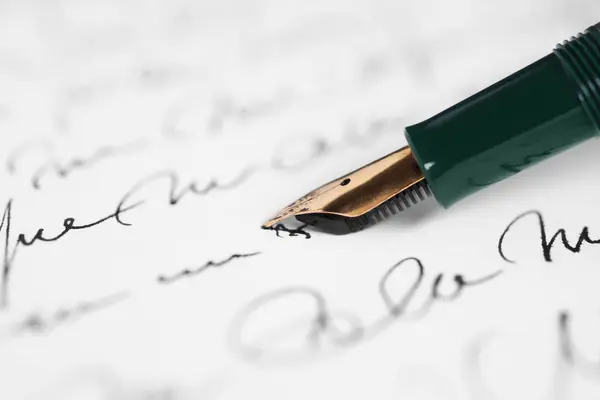 Writing letter with elegant fountain pen, closeup