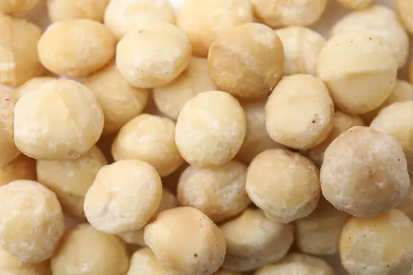 Tasty Peeled Macadamia Nuts Background Top View Stock Image