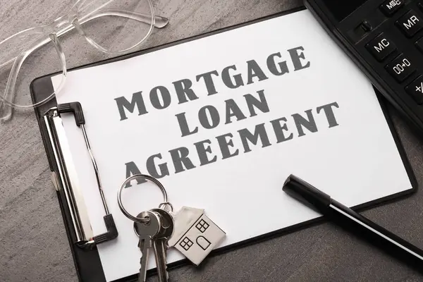 Mortgage loan agreement, house keys and calculator on grey table, closeup