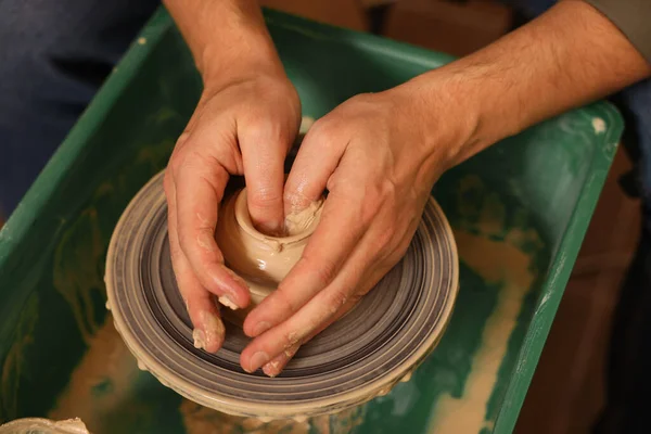Clay crafting. Man making bowl on potter\'s wheel, closeup