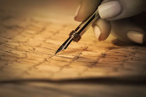Woman writing letter with fountain pen, closeup