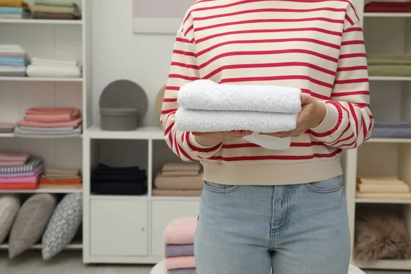 Customer holding towels in home textiles store, closeup. Space for text