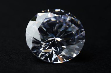 Beautiful shiny diamond on black background, closeup