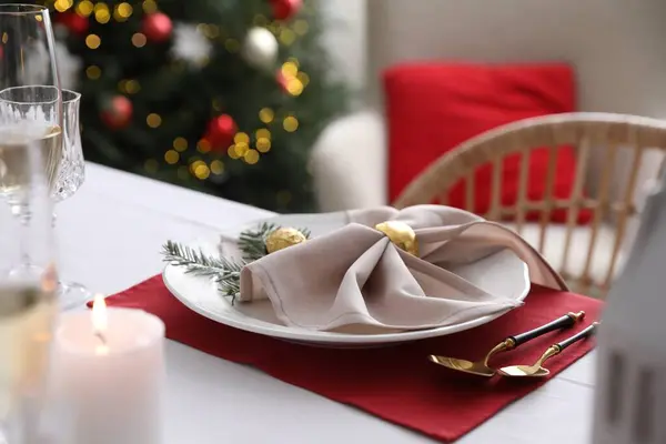 Christmas table setting with beautiful napkin, cutlery and dishware, closeup