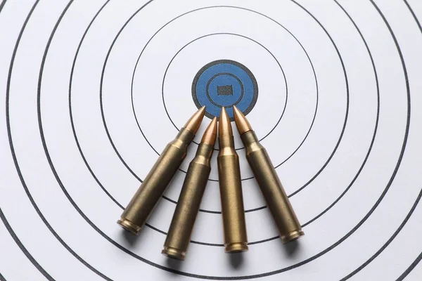 Metal bullets on shooting target, above view