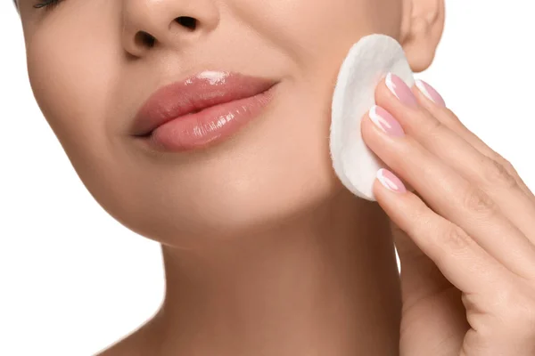 stock image Beautiful woman removing makeup with cotton pad on white background, closeup