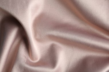 Arkaplan olarak narin pembe kumaş dokusu, yakın plan