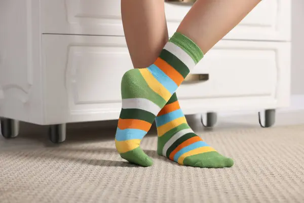 Woman in stylish colorful socks indoors, closeup