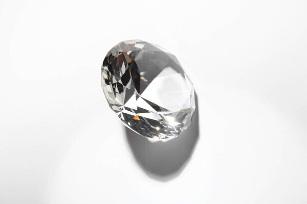One beautiful shiny diamond on white background, top view