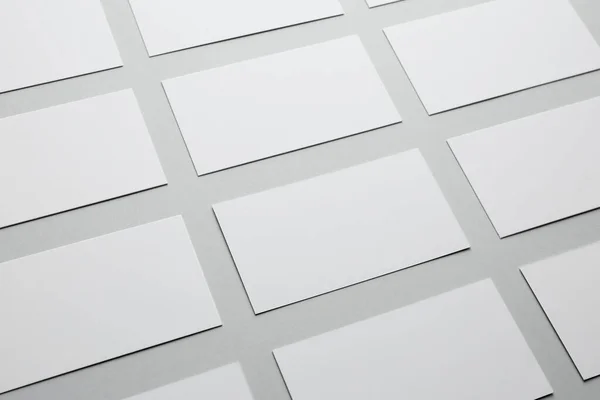 Blank business cards on light gray background, closeup. Mockup for design