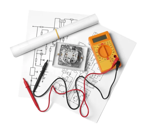 Wiring diagrams, digital multimeter and disassembled light switch isolated on white, top view