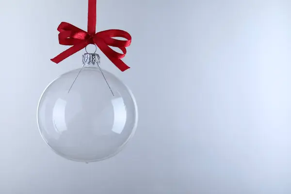 Transparent Glass Christmas Ball Red Ribbon Bow Light Background Space —  Fotos de Stock