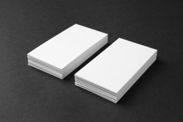 Stacks of blank business cards on black background. Mockup for design