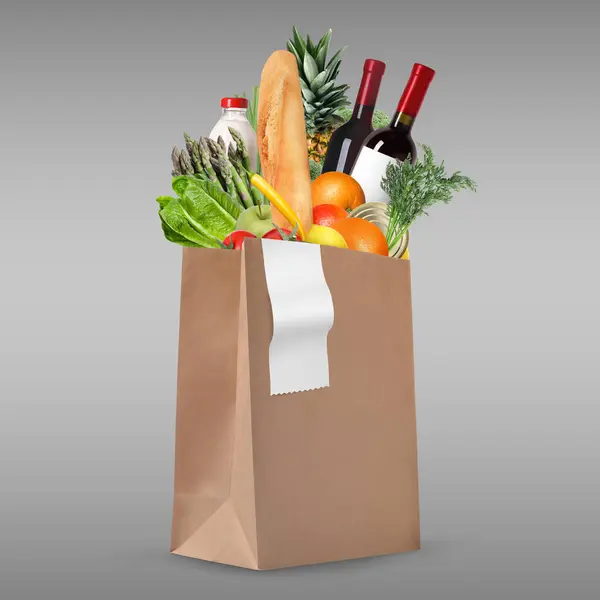 Paper bag with different products and receipt on grey gradient background