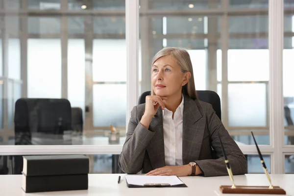 Beautiful woman at table in office. Lawyer, businesswoman, accountant or manager