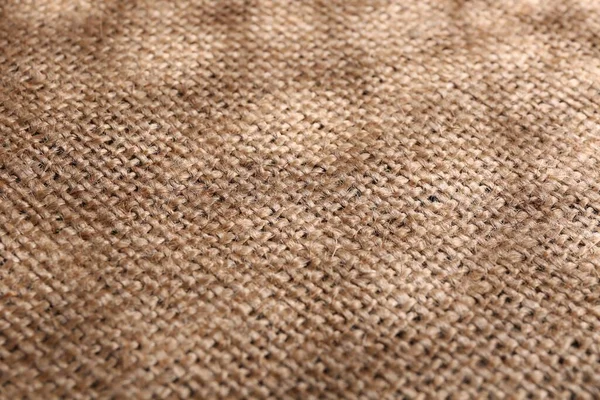 Texture of beige burlap fabric, closeup view