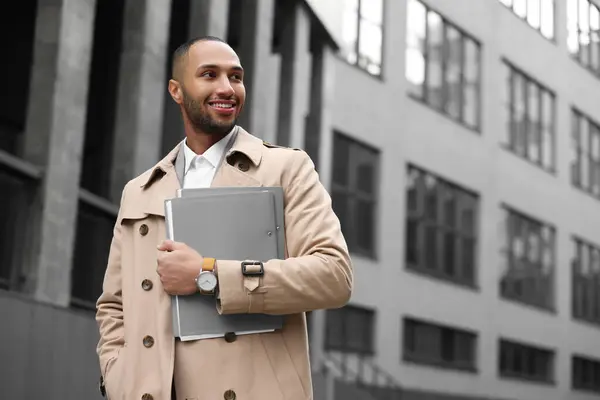 Happy man with folders outdoors, space for text. Lawyer, businessman, accountant or manager