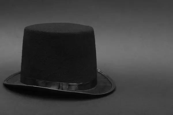One magician top hat on dark grey background, space for text