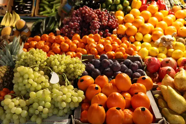Many different fresh fruits on counter at wholesale market