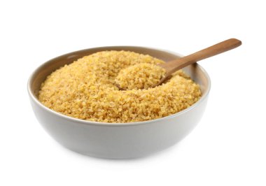 Beyazda çiğ bulgur bulunan kase ve kaşık.