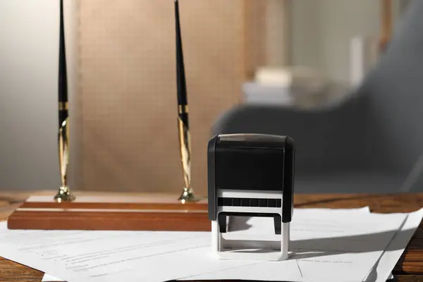 Notary contract. Stamp, documents and pen holder on wooden table