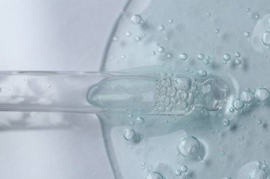 Beyaz arka planda kozmetik serumlu boru, üst görünüm
