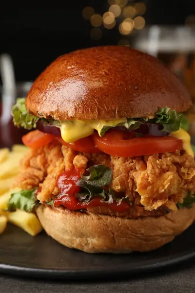 Delicious burger with crispy chicken patty on table, closeup