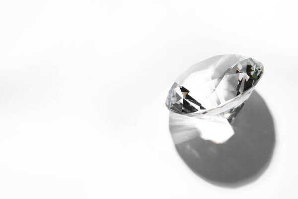 One beautiful shiny diamond on white background, above view. Space for text